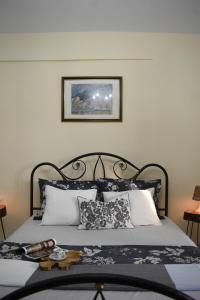 a bedroom with a bed with black and white pillows at Mariana's Apartment in Vatopedi