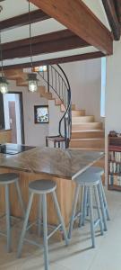 a table and stools in a room with a staircase at Seaside Serenity - Your ultimate beachfront escape in Sheffield Beach +33 photos