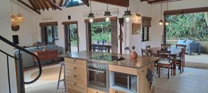 a kitchen and dining room with a stove and a table at Seaside Serenity - Your ultimate beachfront escape in Sheffield Beach