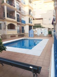 a swimming pool in front of a building at Ferrara playa in Torrox Costa