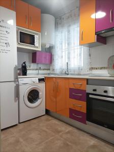 uma cozinha com uma máquina de lavar roupa e uma máquina de lavar roupa em Ferrara playa em Torrox Costa