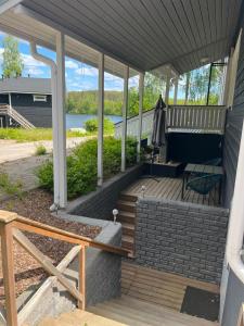 a porch of a house with a bench and a table at Norppa Resort in Savonlinna