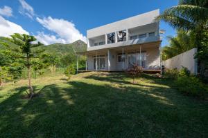 a house with a large yard in front of it at Le Rivage Appartement Mauritius in La Gaulette