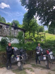 two men are standing next to their motorcycles at Apartment Relax in Plužine