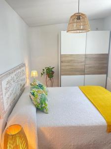 een slaapkamer met een groot bed en een gele deken bij Finca el atardecer- Apartamento El Peral in Los Santos de Maimona