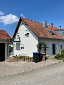 a white house with a red roof at Apartment Schendel in Tettnang