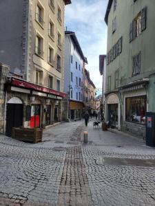 a cobblestone street in a city with buildings at Appartement Aroma Snow in Briançon