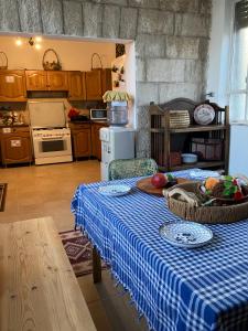 a kitchen with a table with a blue and white table cloth at Darna Hostel in Amman