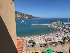 a view of a beach with umbrellas and the ocean at Menton1974 in Menton