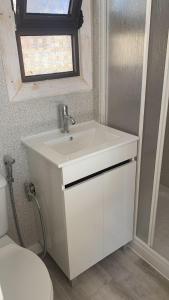 a bathroom with a sink and a toilet at Solmeco Park in Aldeia do Meco