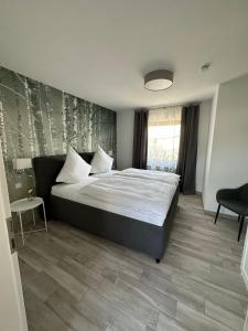 a bedroom with a large bed and a window at Auszeit Birkenhof in Trimbs