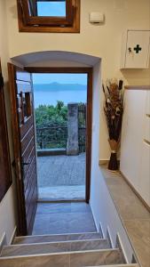 a hallway with a door and a vase of flowers at Sabi2 in Mošćenička Draga