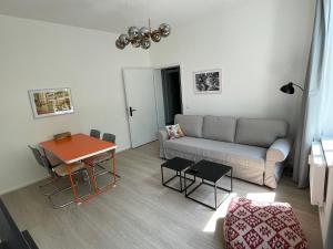 a living room with a couch and a table at FeWo NORDKAPP in Warnemünde