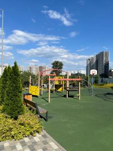 a playground in a park with a roller coaster at Perlina Dnipra in Kyiv