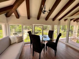 a living room with a couch and a table and chairs at Green Promenade Apartment in Dubrovnik