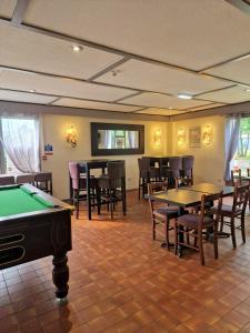 a room with tables and chairs and a pool table at Campanile Hotel Doncaster in Doncaster