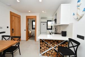 a kitchen with a counter with a pile of logs at Blue Point Hotel Yalikavak in Yalıkavak