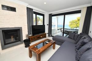 a living room with a couch and a fireplace at Blue Point Hotel Yalikavak in Yalıkavak