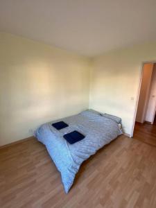 a bedroom with a bed with a blue blanket at Suresnes’s Center in Suresnes