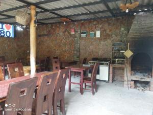 a restaurant with a table and chairs and a stove at Ricky's House in Baños