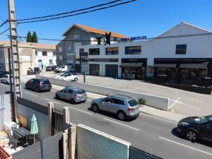 a street with cars parked in front of a building at Maisonnette avec terrasse privative in La Ciotat