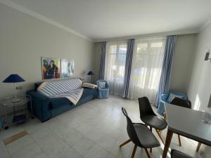a living room with a couch and a table and chairs at Ville Lago Lugano in Porto Ceresio +89 photos