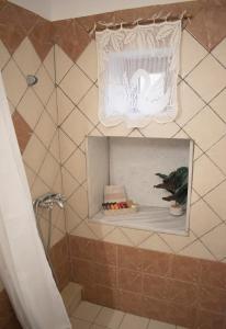 a bathroom with a shower with a curtain and a plant at House of Harmony (Zounaki) in Kamisianá