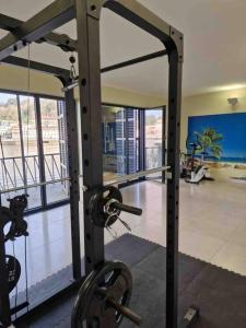 a room with a gym with a large glass window at Central duplex apartment-full view of Douro river in Vila Nova de Gaia