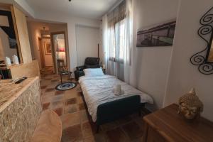 a small room with a bed and a chair at AKAVA garden house in Volos