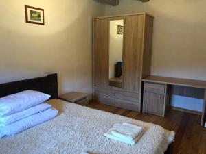 a bedroom with a bed with two towels on it at IT-Hutorok in Tur'ya Pasika