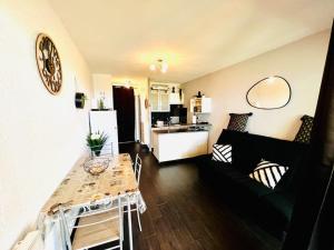 a living room with a couch and a table at Vue Mer\Plage\Parking Gratuit\wifi in Le Barcarès