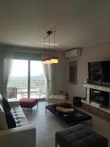 a living room with a couch and a table at Seaview Villa in Néa Epídhavros