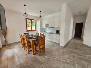 a kitchen and dining room with a table and chairs at Holiday homes Sintija in Rab