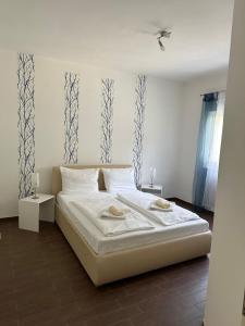 a bedroom with a white bed with two towels on it at Resindenz Benni 7 mit beheiztem grossem Pool in Medulin