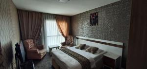 um quarto de hotel com uma cama e duas cadeiras em İNCİ HOUSE em Kırac