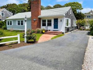 a house with a blue door and a white fence at 3 Shore Road Extension West Harwich Cape Cod - - A Shore Thing in West Harwich