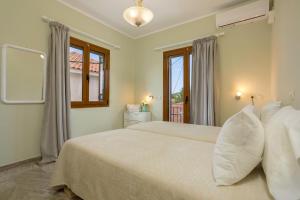 a bedroom with two beds and a window at Elena Hara in Alikanas