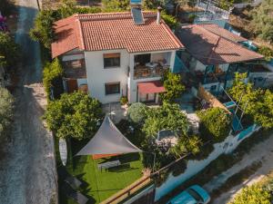 an aerial view of a house with a tent at AKAVA garden house in Volos