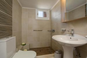 a bathroom with a sink and a toilet at Elena Hara in Alikanas +33 photos