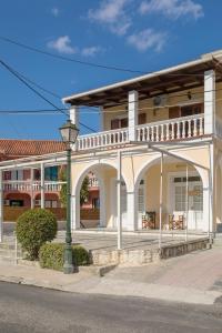 a white building with a street light in front of it at Elena Hara in Alikanas