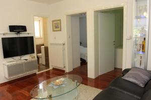 a living room with a couch and a glass table at Holiday House Pine Tree in Nerežišća +86 photos