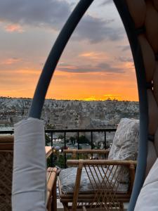 a balcony with chairs and a view of a city at Sunset Cave in Göreme