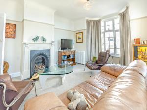 a living room with a couch and a fireplace at Crossways Mansions in Bexhill