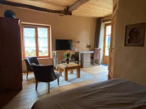 1 dormitorio con 1 cama, mesa y sillas en Gites&chambres d hôtes Les granges du Fournel, en Saint-Lattier