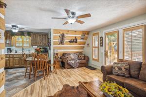 a living room with a couch and a table at Smokey Max Chalet in Sevierville