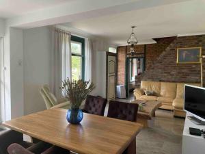 sala de estar con mesa y sofá en Charming authentic renovated farm, en Cadier en Keer