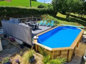 an overhead view of a swimming pool with chairs and a table at Millstone Gite 2, two bed apartment + shared pool in Chassenon