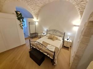 a bedroom with a bed in a white room at La Dimora nel Borgo in Locorotondo