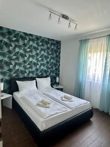 a bedroom with a large bed with a blue wall at Resindenz Benni 4 mit beheitzem grossem Pool in Medulin