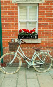 a bike parked in front of a brick building with a window at The Hideaway in Swanage